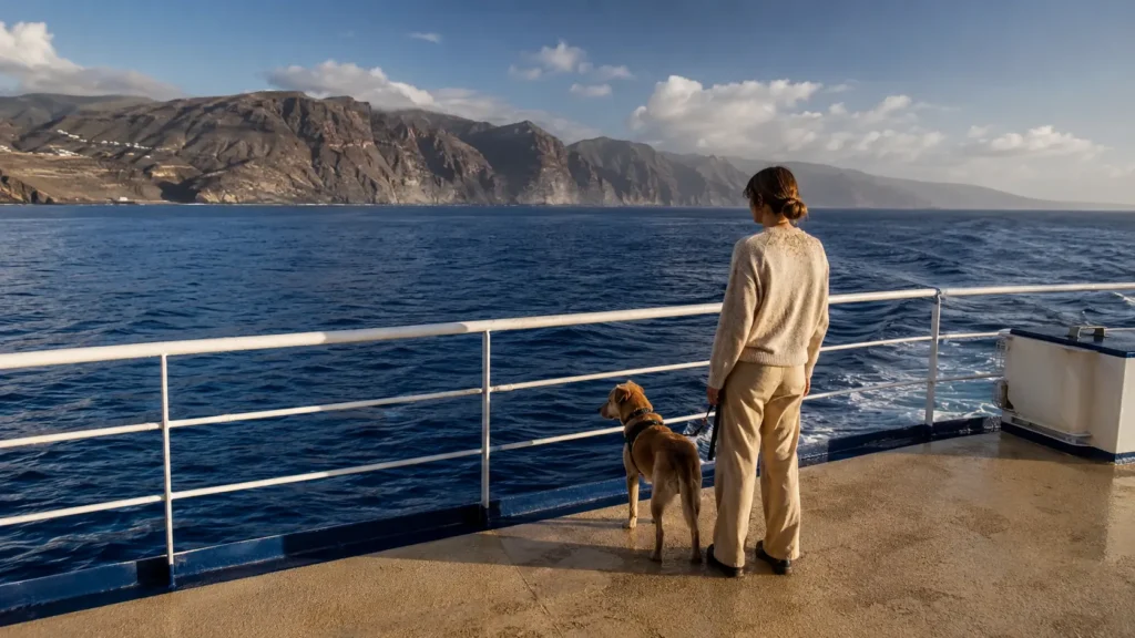 Pasajero con un perro en la cubierta exterior de un ferry interinsular entre La Gomera y Tenerife durante la travesía por el Atlántico